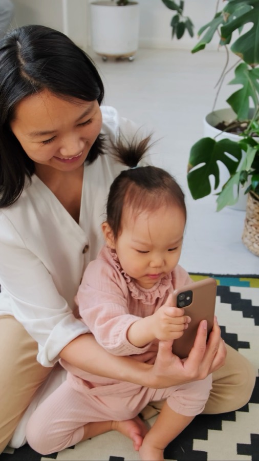 A first birthday, a child in a parent’s arms